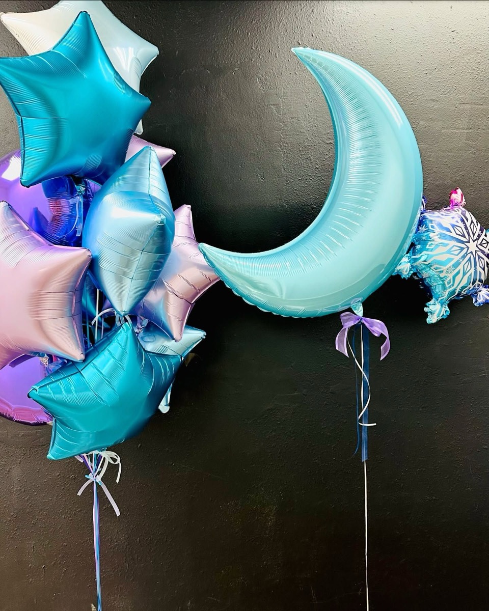 White balloon arrangement hanging from a ceiling
